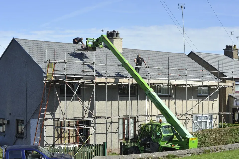 Roof replacement project by Berkeley Roofing using scaffolding and lift for safe installation