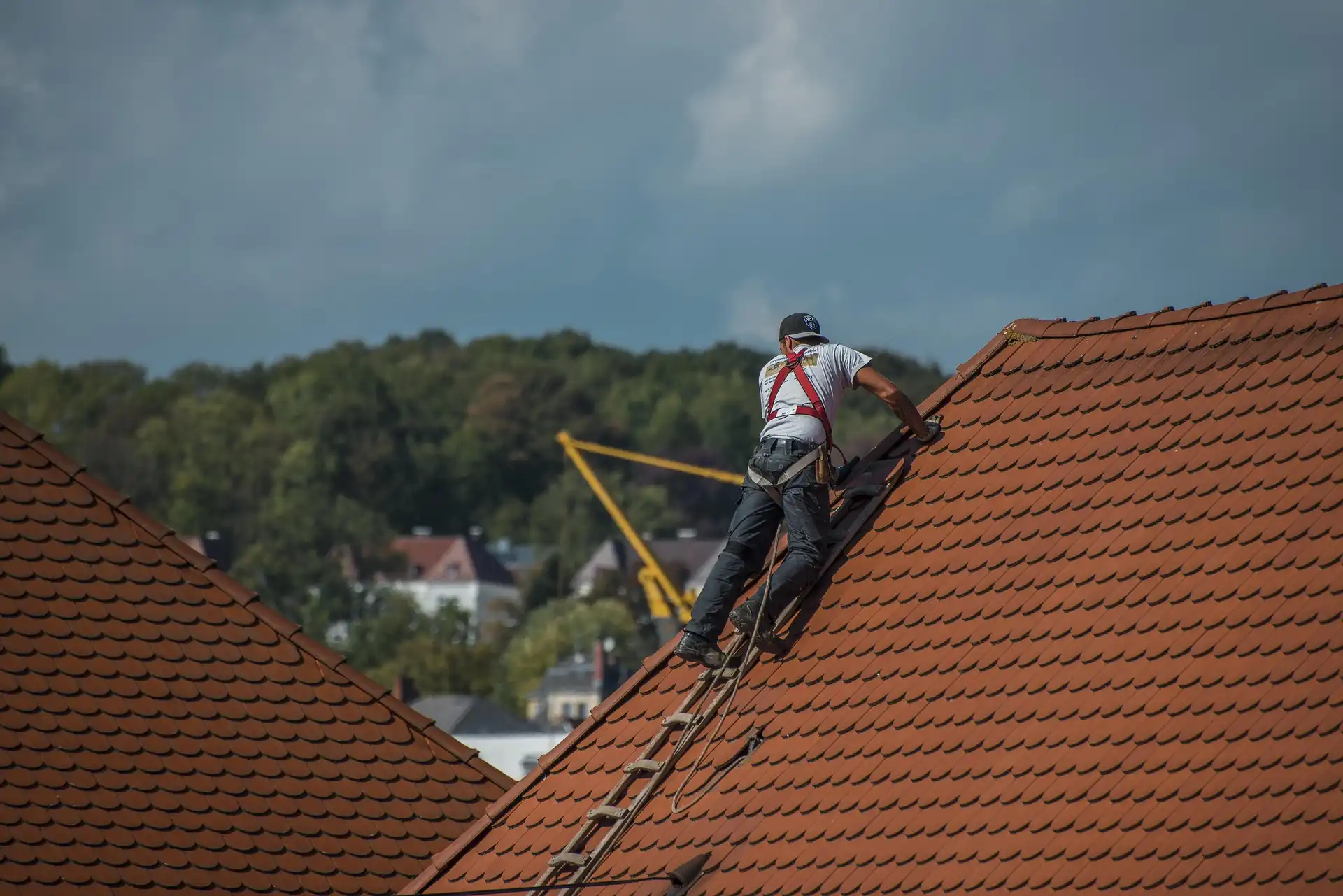 Professional roofer from Berkeley Roofing performing steep-slope roof repair service